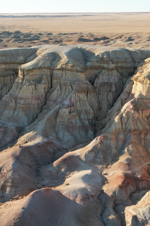 Best 6-Day Gobi Tour Discover Mongolia - Day 5: Tsagaan Suvarga (White Stupa) and layered cliff colors at golden hour